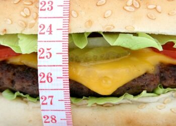 Una hamburguesa y una cinta de medir en una imagen de archivo.