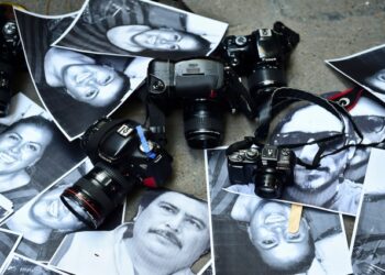 View of photos of killed journalists and cameras outside the Veracruz state representation office during a journalists protest in Mexico City on February 11, 2016. Mexican journalist Anabel Flores Salazar's funeral took place Wednesday after she was found killed at a road after being kidnapped Monday in Veracruz state, one of the most dangerous for journalists.  AFP PHOTO/RONALDO SCHEMIDT / AFP / RONALDO SCHEMIDT