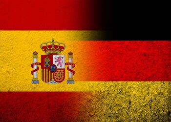 The national flag of Germany with Kingdom of Spain National flag. Grunge background
