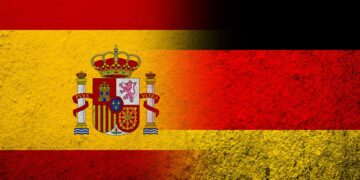 The national flag of Germany with Kingdom of Spain National flag. Grunge background